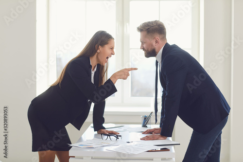 Business conflict. Competition conflict dispute business angry people at a table in an office