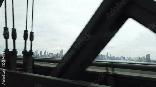 Driving Over New York Bridge on East River With Overview on City Downtown, View From Right Passenger Seat in Moving Vehicle