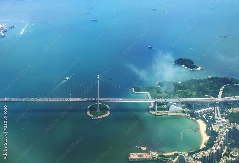 Aerial view of Hong Kong islands with suspension bridge from a flying airplane