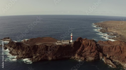 video 1The camera flies to an old lighthouse standing on a rocky cape. Tenerife, Cape Teno