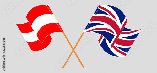 Crossed and waving flags of Austria and the UK