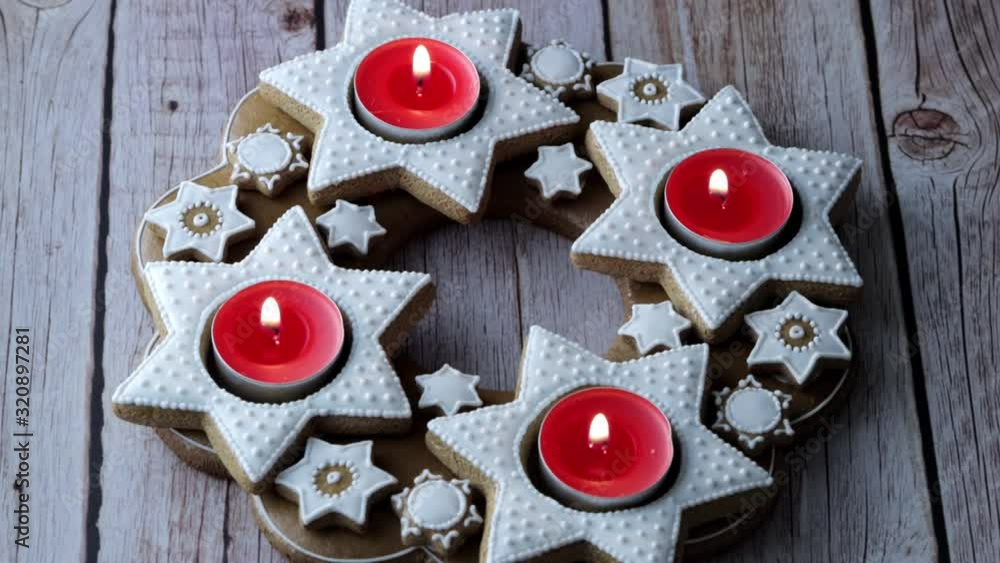 Christmas advent wreath of star-shaped gingerbread with red tea candles Christmas advent wreath of star-shaped gingerbread with red tea candles