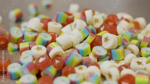 Colorful caramel candies bouncing and falling all over photo