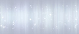 Bright white bokeh lights abstract background. Flying silver particles or dust. Vivid lightning. Merry christmas design. Blurred light dots.