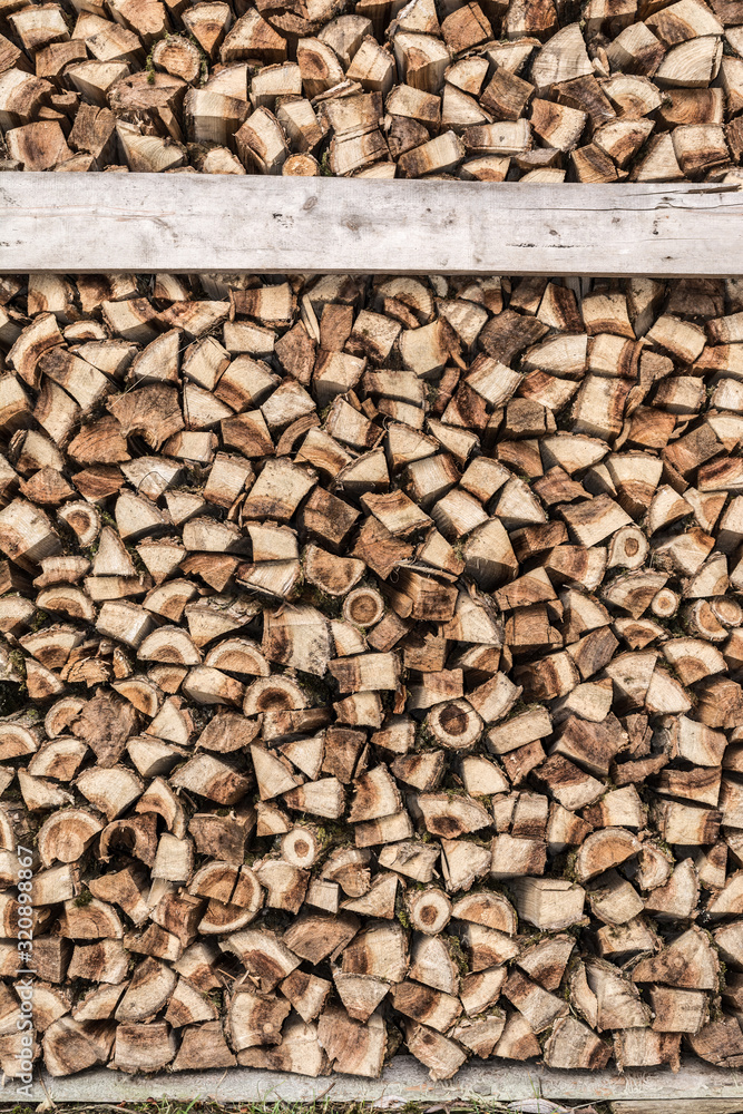 Background of stacked, dry chopped logs used for firewood. Background of stacked, dry chopped logs used for firewood.
