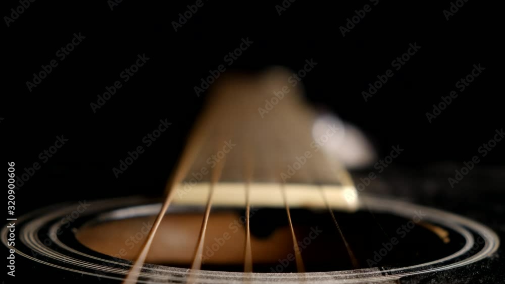Unique perspective of guitar strings and fretboard of an acoustic guitar Unique perspective of guitar strings and fretboard of an acoustic guitar