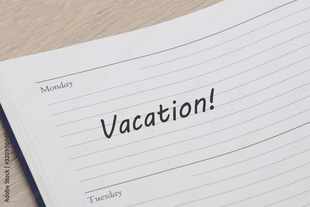 Vacation diary reminder open on desk Vacation diary reminder open on desk