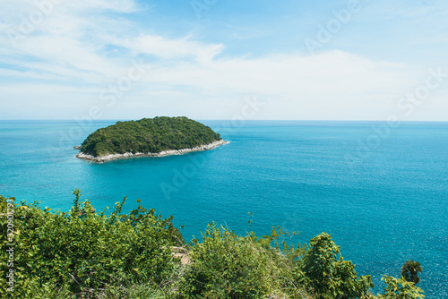 view from the cliff to the turquoise sea and the island © Svetlana
