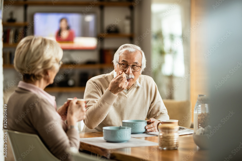 Senior man enjoying in breakfast with his wife at home. Senior man enjoying in breakfast with his wife at home.