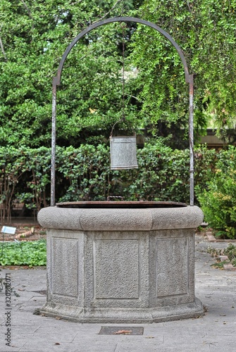 Vintage water well in the Botanical garden of Valencia photo