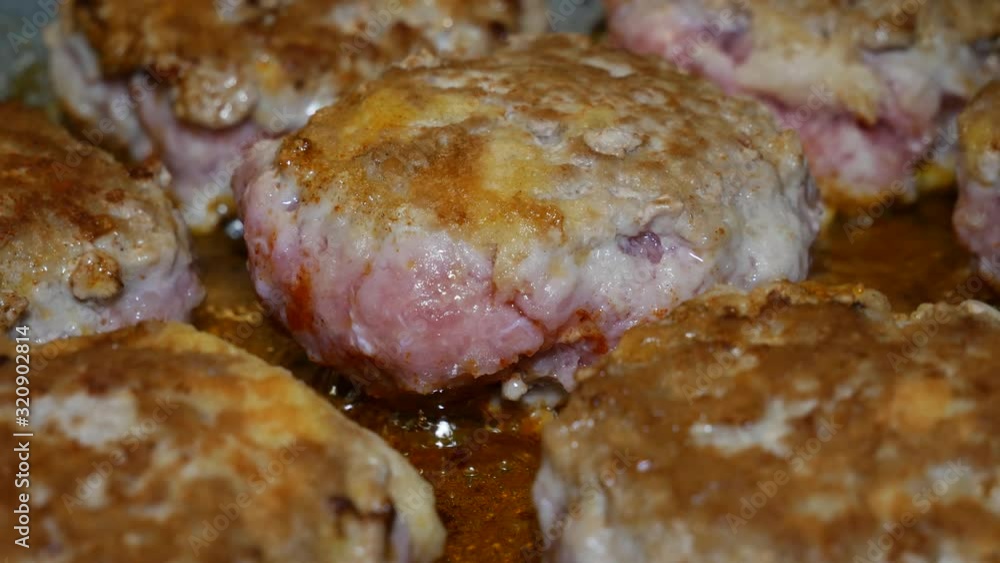 Hand held shot of cooking cutlet (kotlet) made out of minced meat. Eastern European grandmother's (babushka) style cooked food. Close up. Hand held shot of cooking cutlet (kotlet) made out of minced meat. Eastern European grandmother's (babushka) style cooked food. Close up.