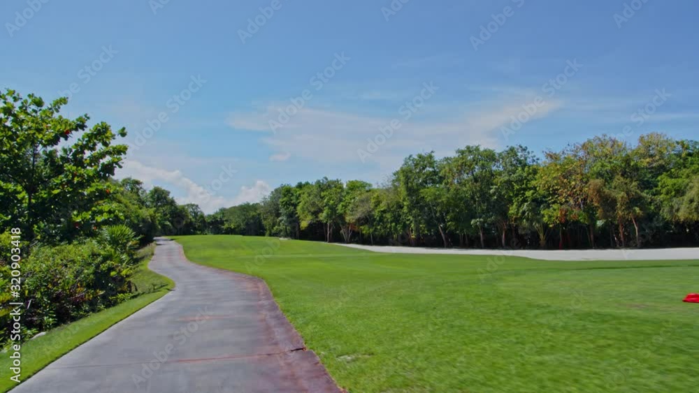 Driving Fast through Golf Course Pathway.
Wide View of Green Grassland and Woods. Driving Fast through Golf Course Pathway.
Wide View of Green Grassland and Woods.
