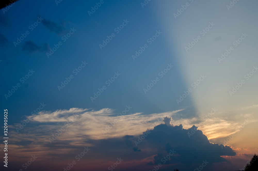 Sunset / sunrise with clouds, light rays and other atmospheric effect