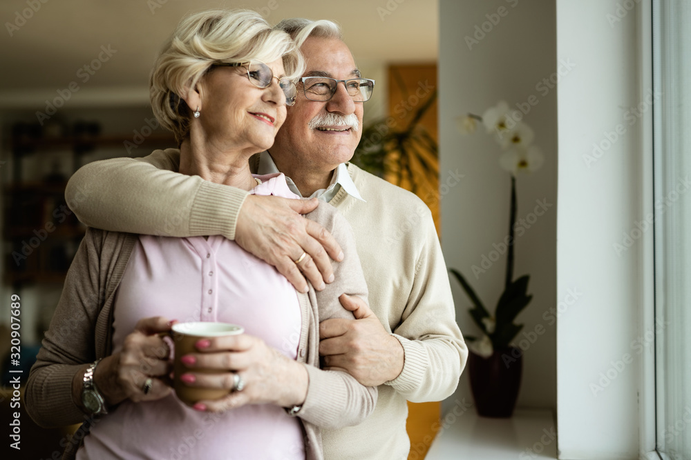 Loving senior couple day dreaming while looking through the window. Loving senior couple day dreaming while looking through the window.