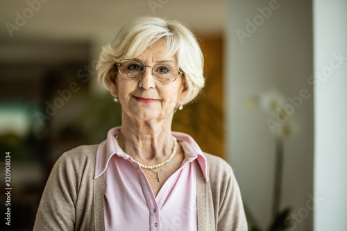 Portrait of smiling mature woman at home.