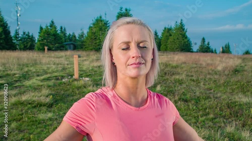 Slow motion orbit of a young woman with grateful expression connecting with nature photo