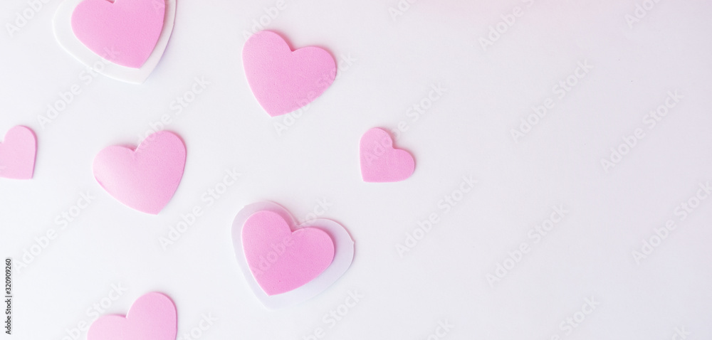 Pink valentine hearts on white background with copy space.