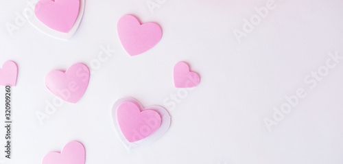 Pink valentine hearts on white background with copy space.