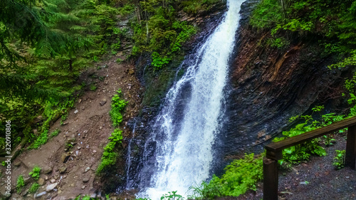 Guk Falls breaks through rocks in Carpathians mountains. Travel concept.
