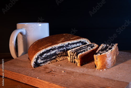 Homemade strudel with poppy seeds and salt on a wooden board
