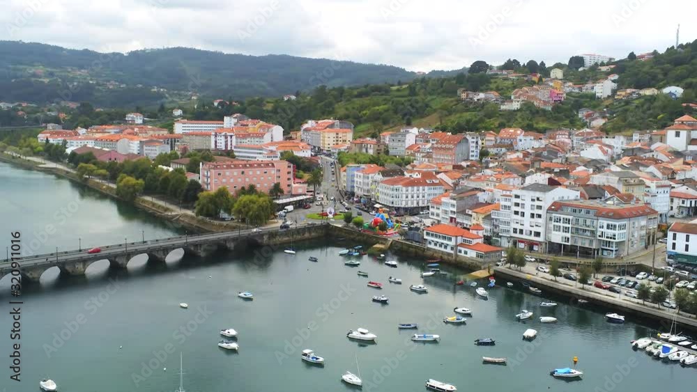 Pan right Aerial view of Pontedeume, a Galician community in northwestern Spain. Pan right Aerial view of Pontedeume, a Galician community in northwestern Spain.
