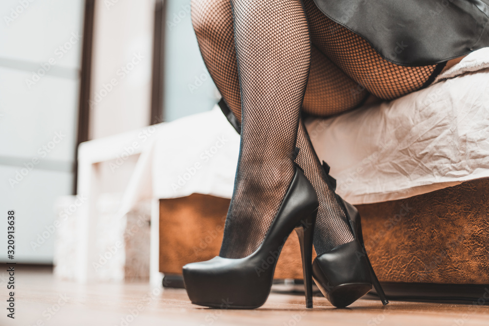 sexy slim woman's legs in black fishnet stockings and black leather high heels  shoes Stock Photo | Adobe Stock