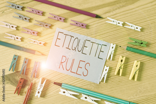 Text sign showing Etiquette Rules. Business photo text customs that control accepted behaviour in social groups Colored clothespin papers empty reminder wooden floor background office photo