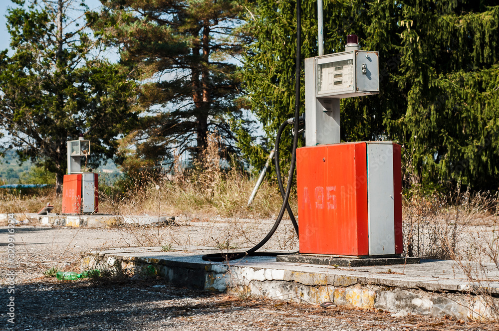 Old abandoned vintage obsolete petrol fuel gas dispenser in former