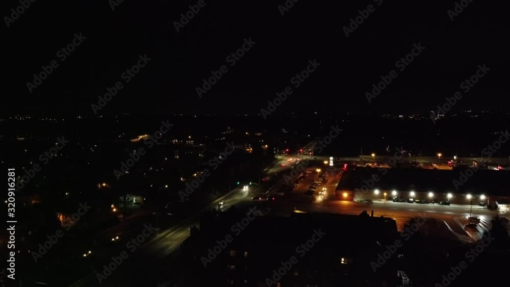 Traffic Near Shopping Mall Plaza at Night Drone Aerial View With City Street Lamps and Night Lights Traffic Near Shopping Mall Plaza at Night Drone Aerial View With City Street Lamps and Night Lights