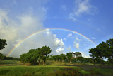 Scenic shot of the golf course with the rainbow across the sky