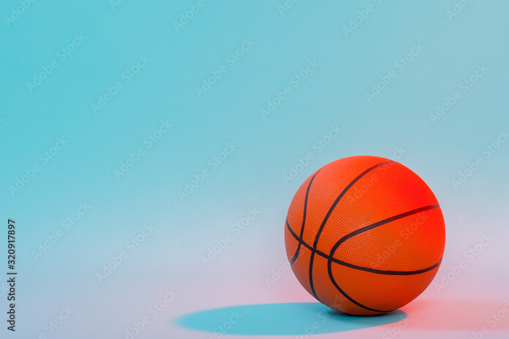 Basketball ball isolated on blue background. Blue neon Banner Art concept Basketball ball isolated on blue background. Blue neon Banner Art concept
