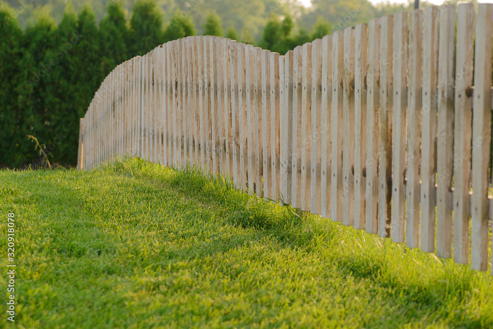 Low wood fence and lawn grass