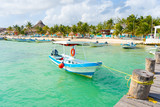 Puerto Morelos seaside view with sea and boats. Caribbean sky with clouds. White sand shore. Background or wallpaper. Yucatan. Quintana roo. Mexico. Riviera maya.