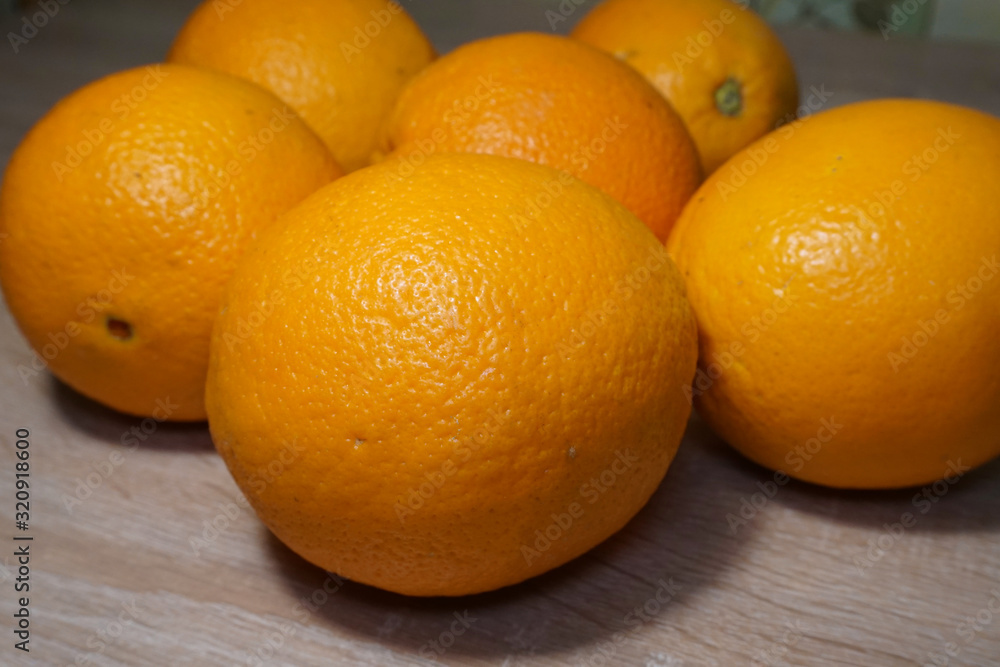 several large ripe oranges on a wooden table several large ripe oranges on a wooden table