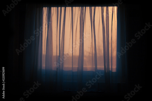 closed window with transparent curtains