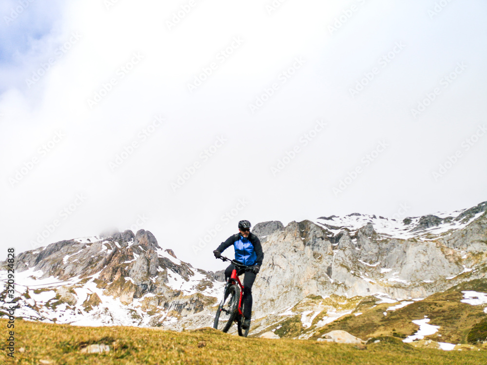 Man riding a mountain bike in the snowy mountains