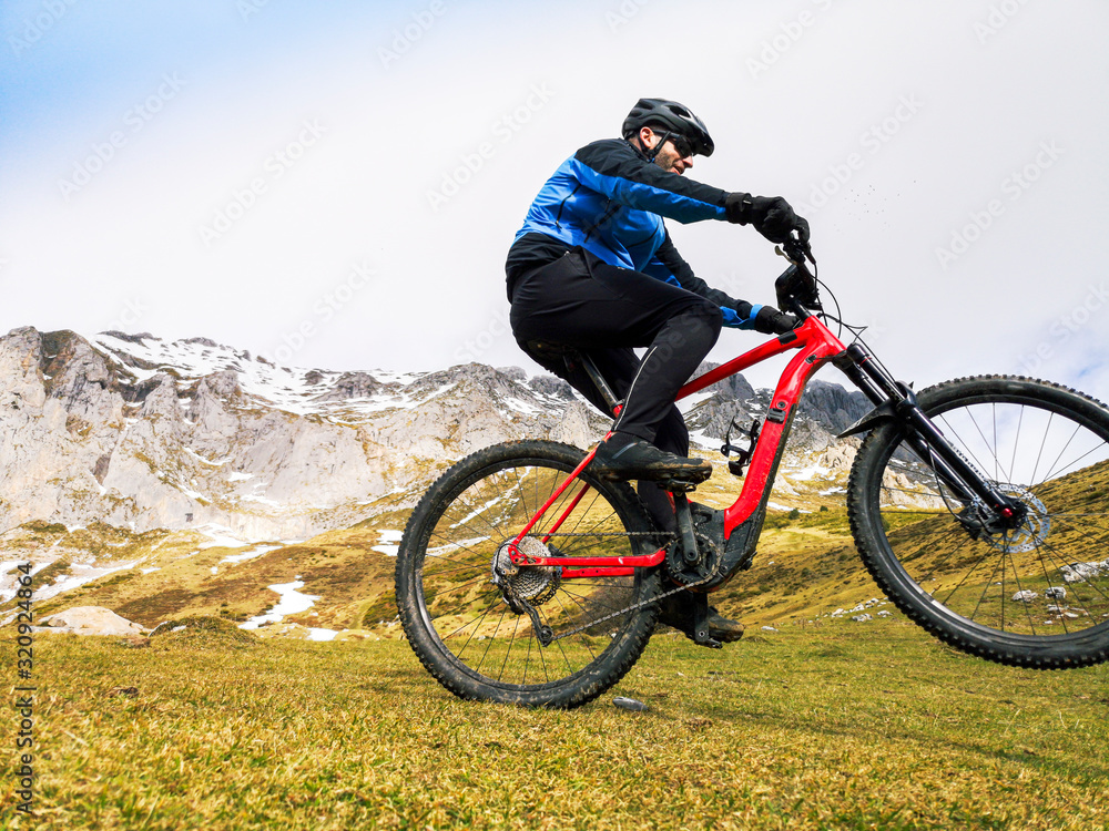 Man riding a mountain bike in the snowy mountains