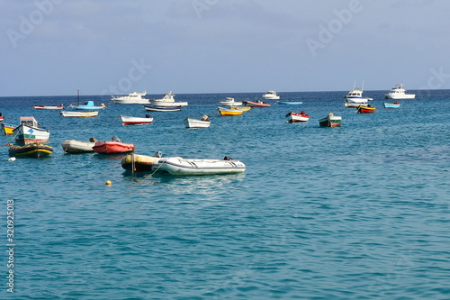 Boats, yachts and fishing boats on a blue sea moored at a seashore © Grazyna Nowicka