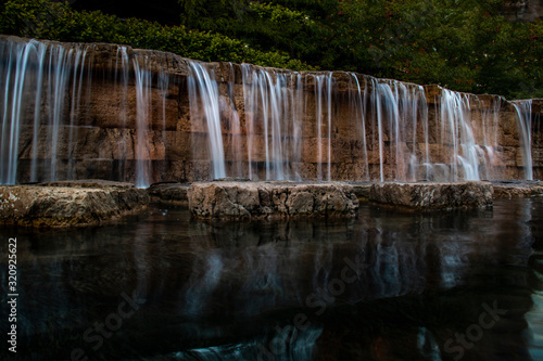 Waterfall on a stone wall at night