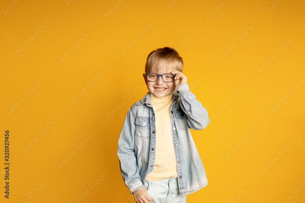 Child on a yellow background boy with a package of vegetables