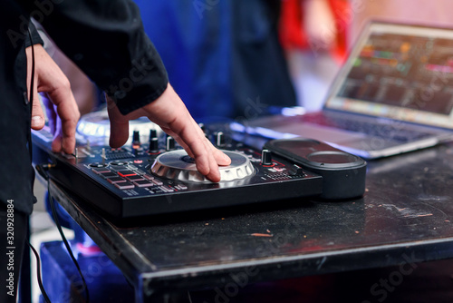 Close up of hands spinning the decks at the nightclub