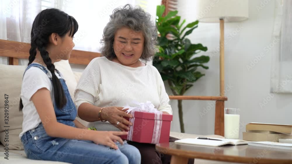 4K, Happy asian family, Relationships and caring for each other within the family, The little niece gave a gift to an adult relative. 4K, Happy asian family, Relationships and caring for each other within the family, The little niece gave a gift to an adult relative.