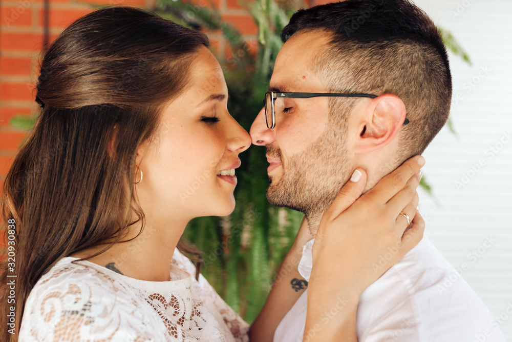Close up portrait of newlywed couple with close eyes caressing and kissing on their wedding day. Love concept. Close up portrait of newlywed couple with close eyes caressing and kissing on their wedding day. Love concept.