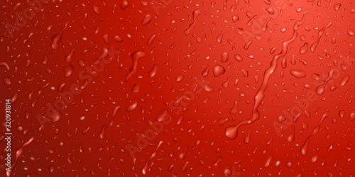 Background with drops and streaks of water in red colors, flowing down the surface