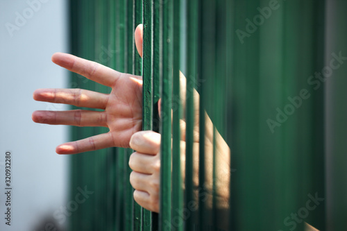 close up of prisoner hand in jail