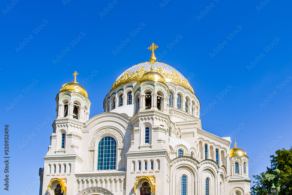 Christian church with beautiful golden domes against the blue sky