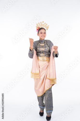 A beautiful Malaysian traditional female dancer performing a cultural dance routine called Tarian Joget in a traditional dance outfit. Full length isolated in white.