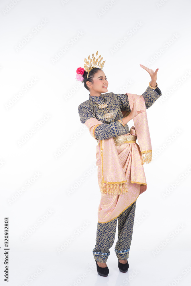 A beautiful Malaysian traditional female dancer performing the dance steps of a cultural dance routine called Tarian Inang in a traditional dance outfit. Full length isolated in white.