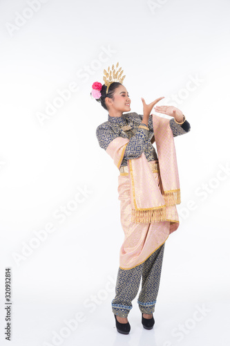 A beautiful Malaysian traditional female dancer performing the dance steps of a cultural dance routine called Tarian Inang in a traditional dance outfit. Full length isolated in white. photo