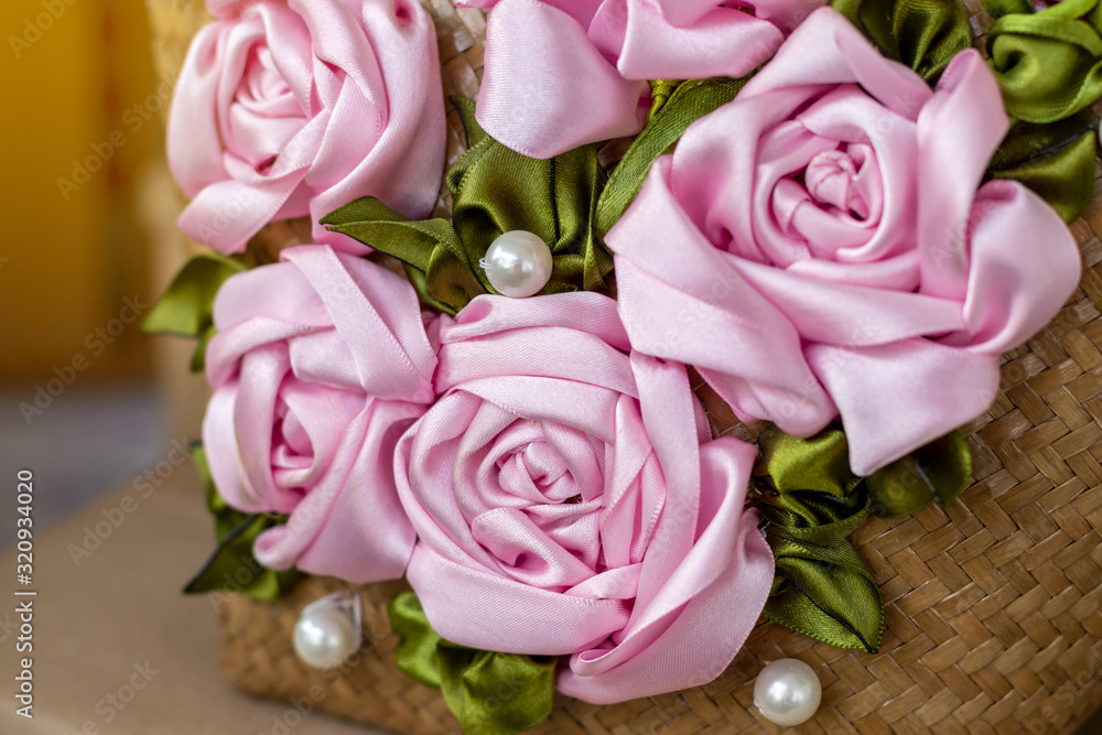 Close-up of artificial roses made from pink ribbons. Close-up of artificial roses made from pink ribbons.